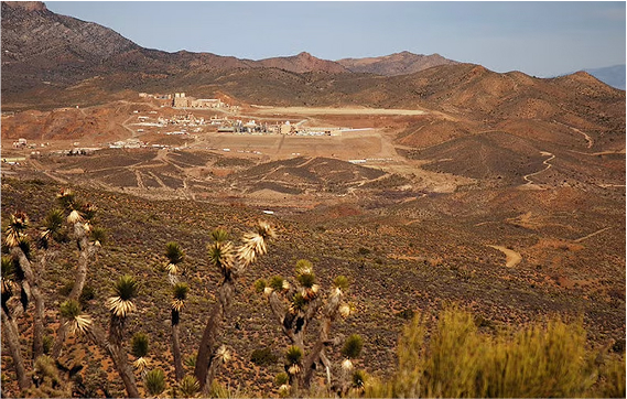 Log view of mountains with mining facility